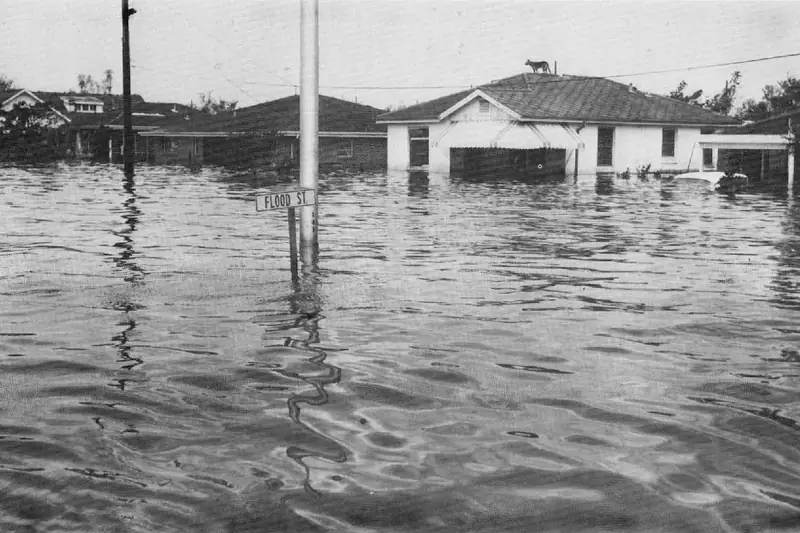A flooded New Orleans street of single-storey houses after the 1965 hurricane